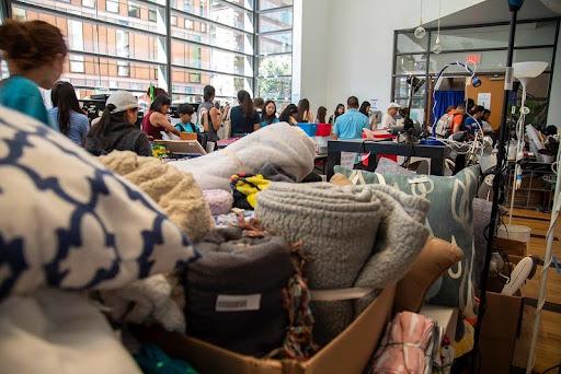 图像 of donations and people shopping at the green sale